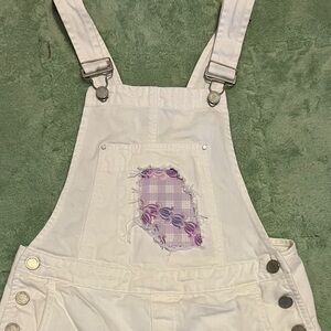 Upcycled BlankNYC Palaka and Crown Flower print overall shorts, white denim